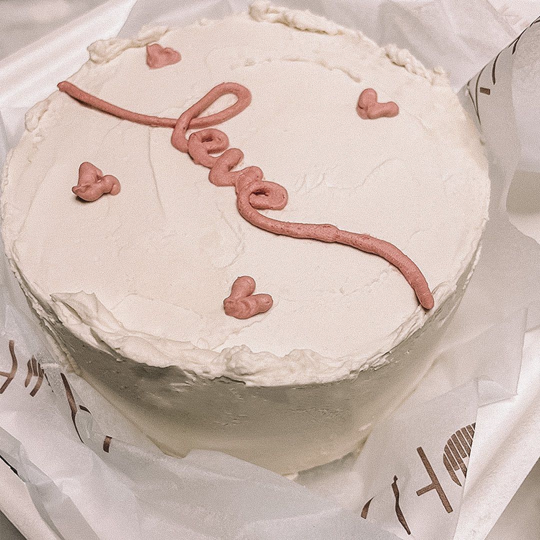 A blush heart cake with hand-piped script